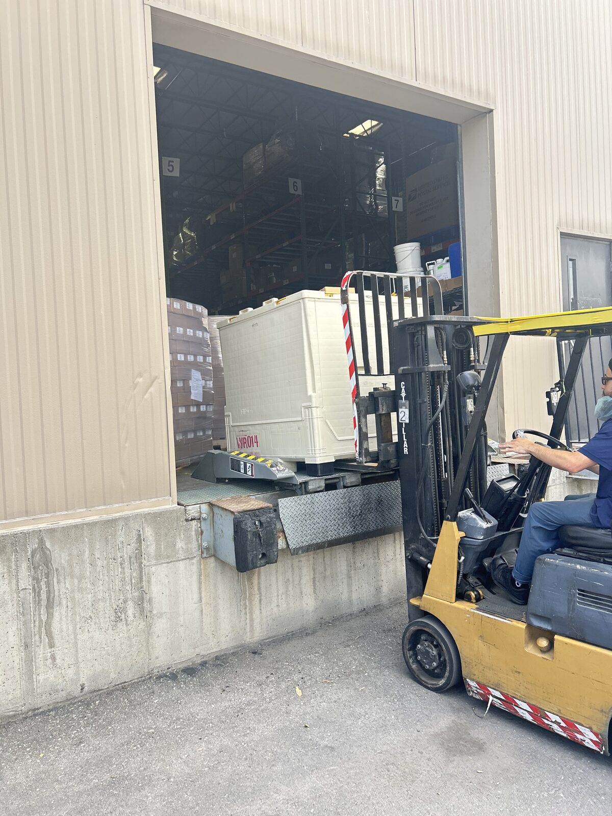 Forklift loading freight at a warehouse dock