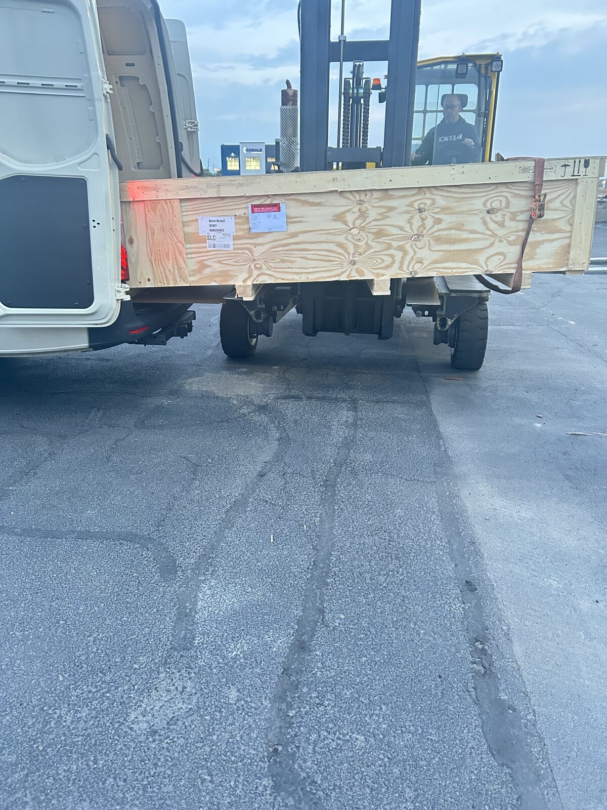 Loading a freight crate behind the van