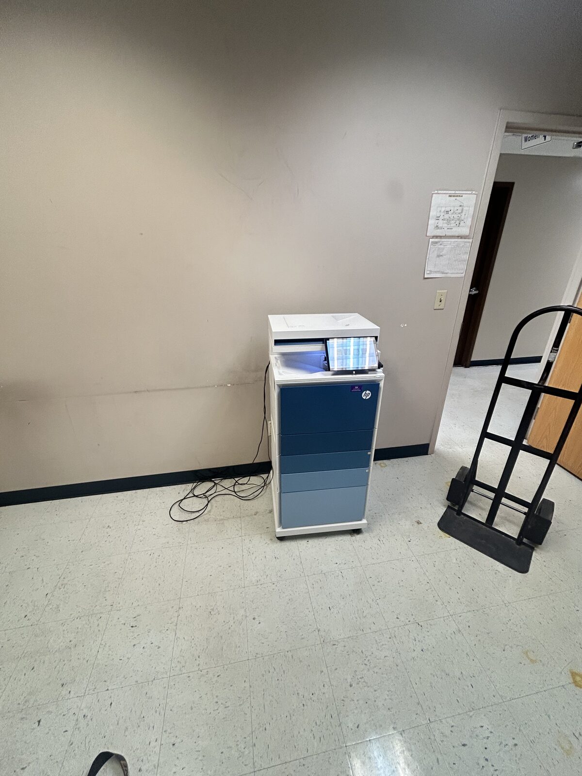 Relocating an office printer with a hand truck